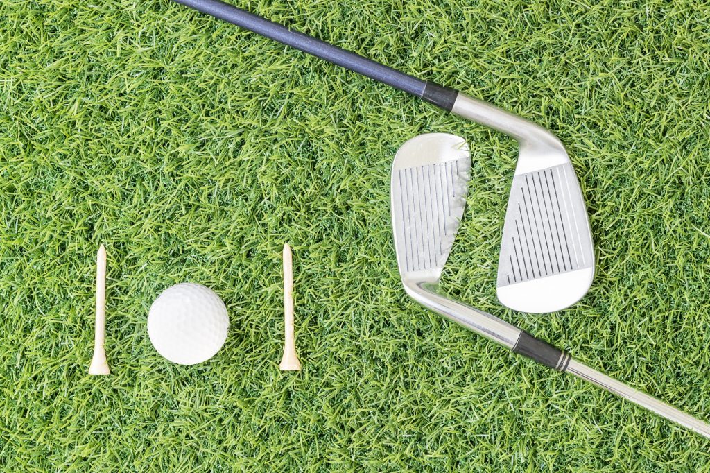 Golf club and golf ball on green grass-7
